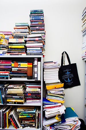 UC Merced office, school books piled high.